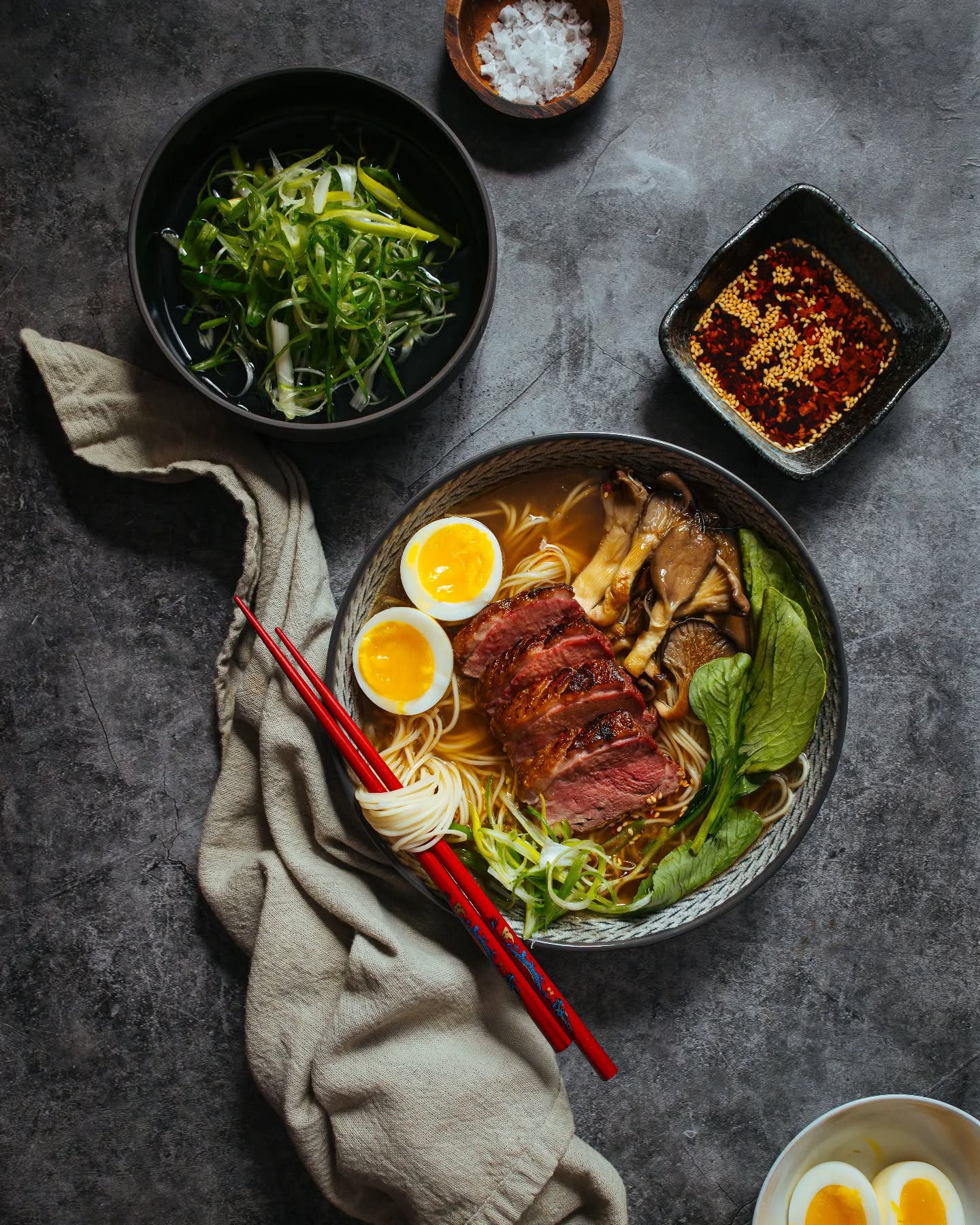 Overhead shot of a steak ramen bowl with soft-boiled egg, styled by Phototype