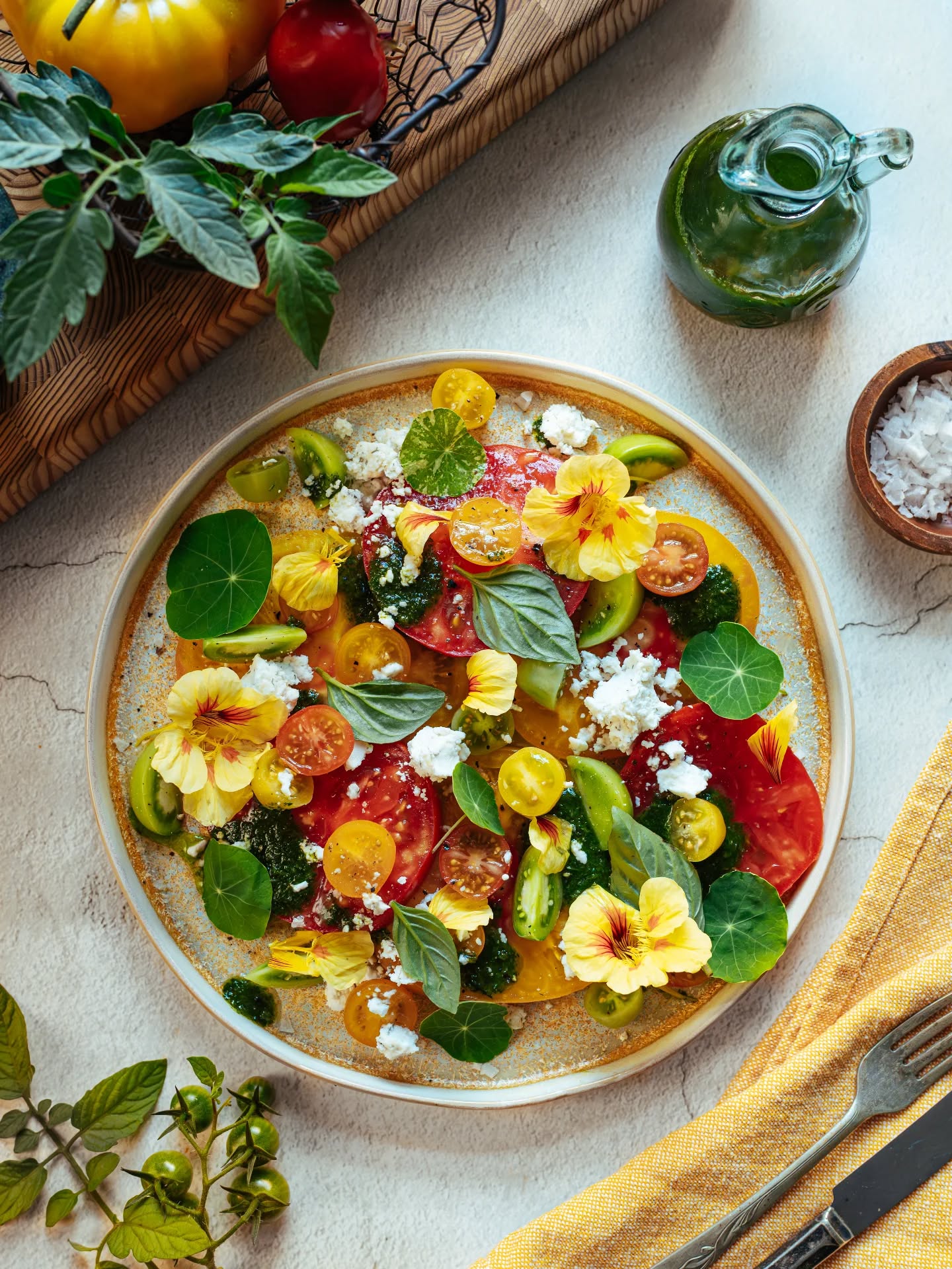 Heirloom tomato salad with edible flowers, styled by Phototype